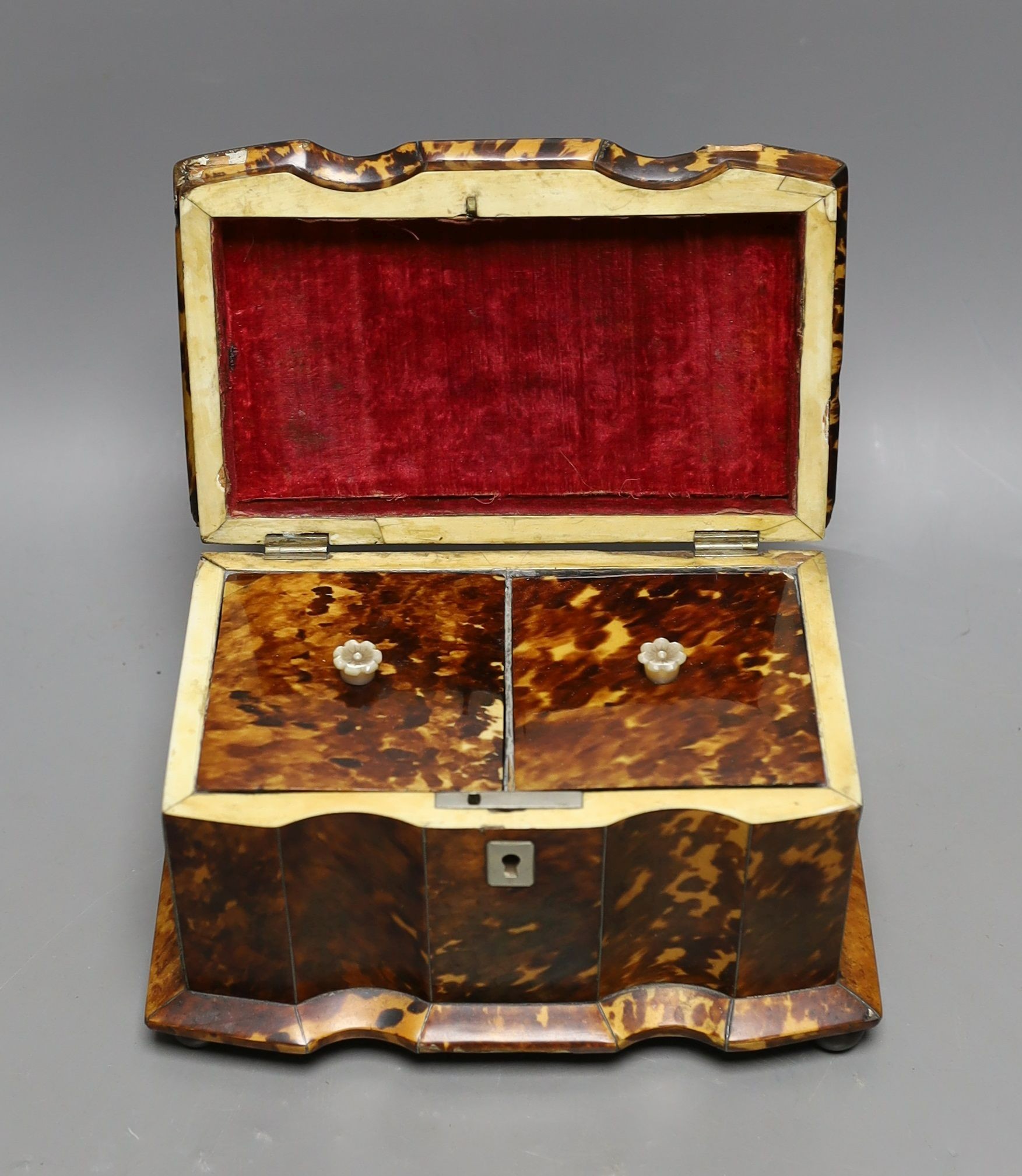 A 19th century tortoiseshell veneered tea caddy, ivory veneered edging, 20cms wide